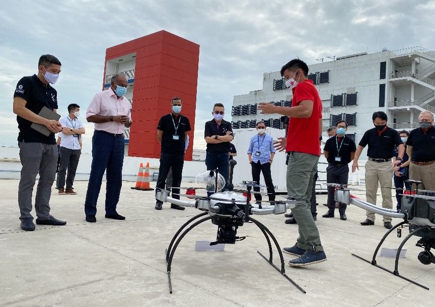Minister K. Shanmugam (in pink shirt) listening to a presentation on the drone features and capabilities during his visit to Tuas View Fire Station on 16 September 2020