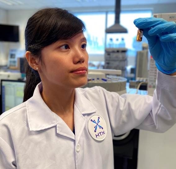 Zan Xin examining a lab sample prepared for explosive analysis (Photo: HTX)