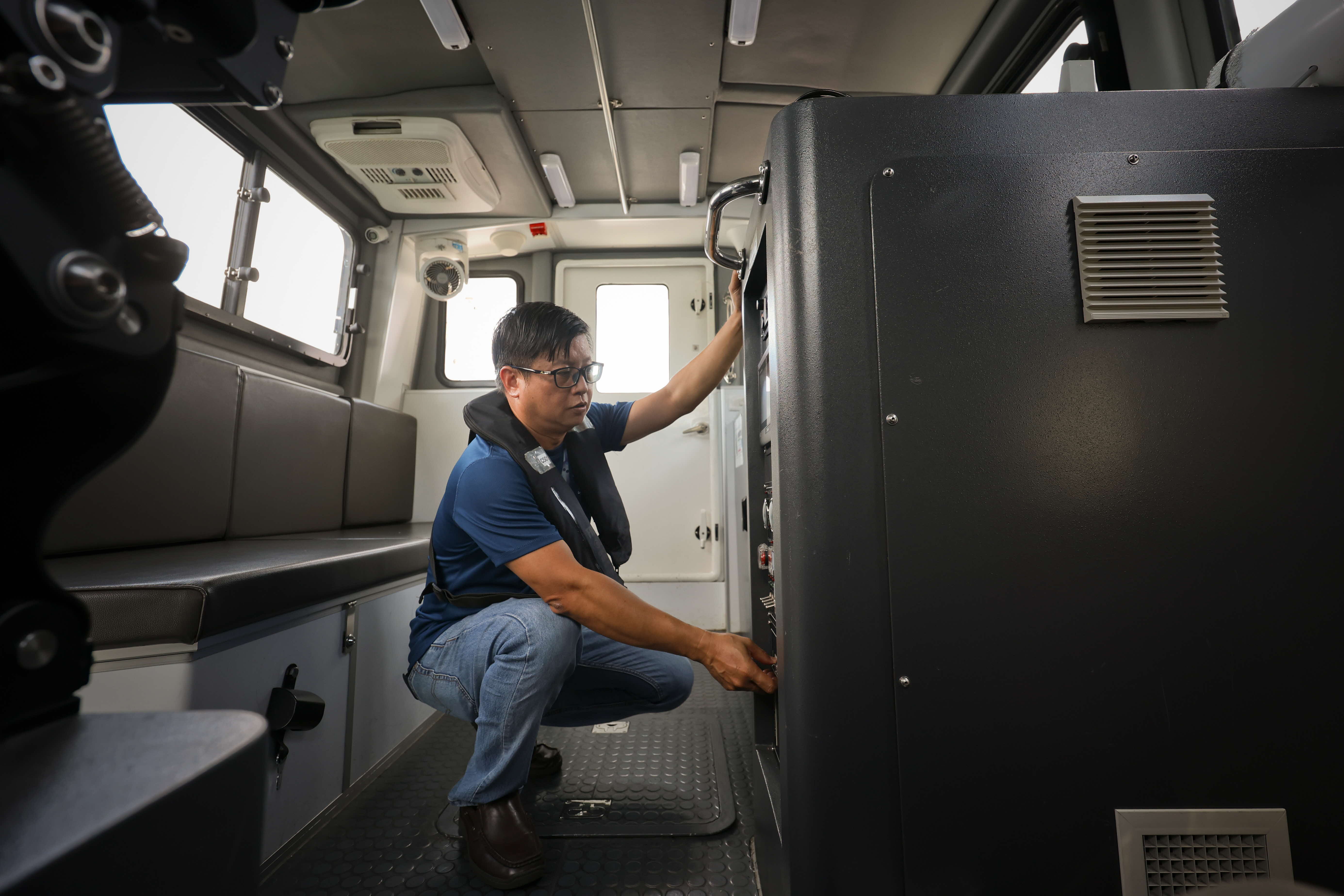 HTX Marine Systems engineer Li Chin Koon inspecting an SPF Marine Reservoir Patrol Boat in the lead up to NDP 25