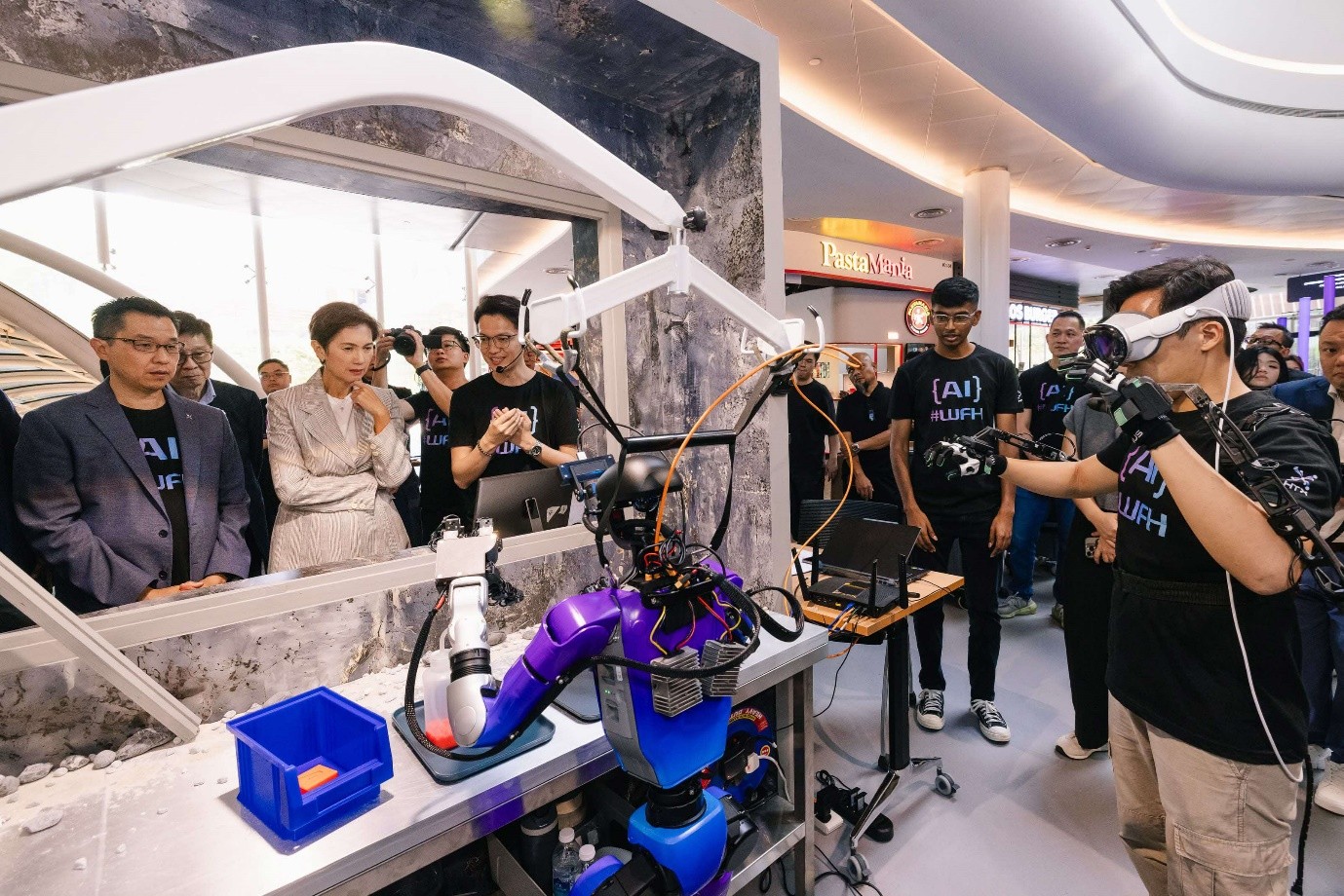 Group of people looking at robot