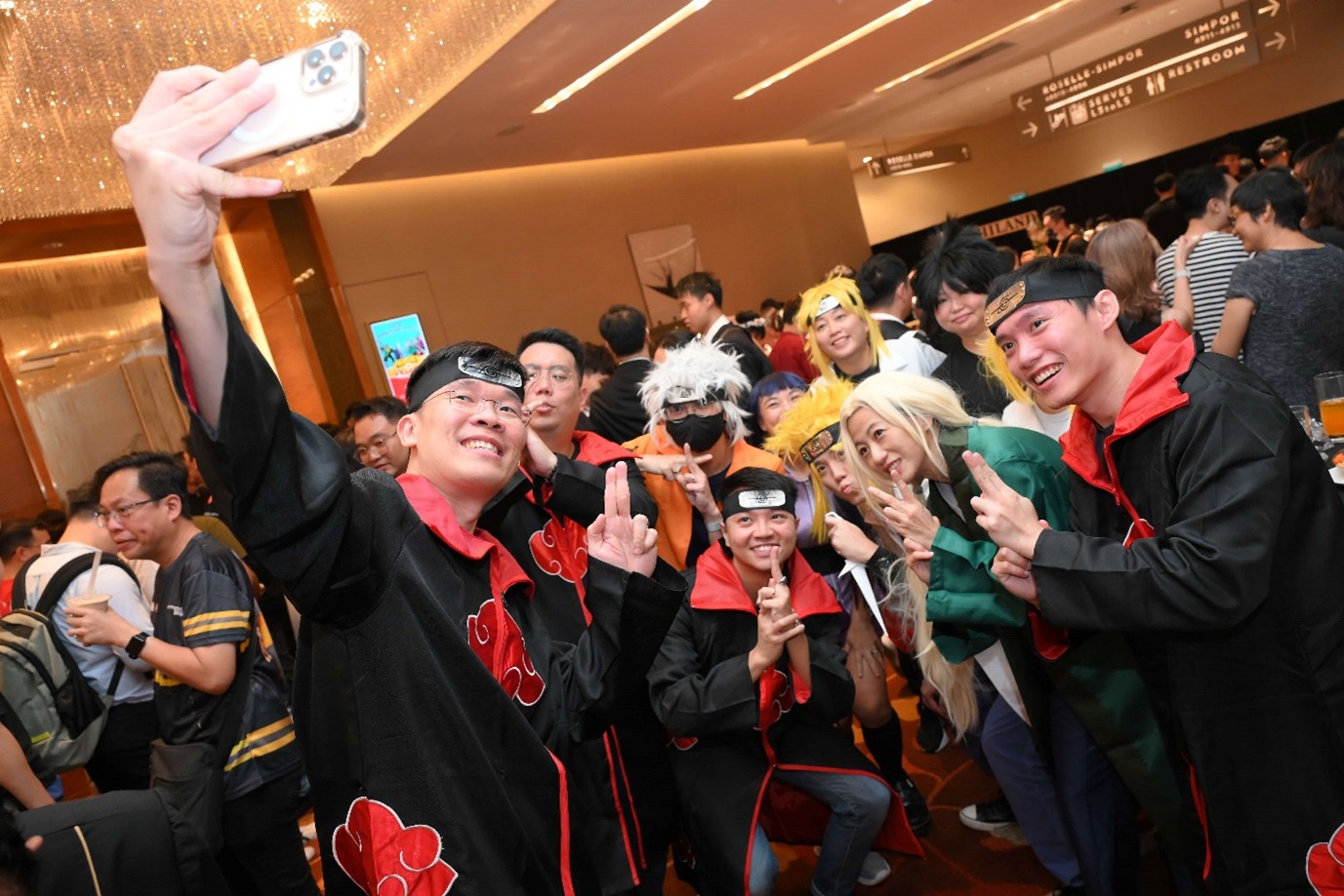 A group of people in costumes posing for a selfie.