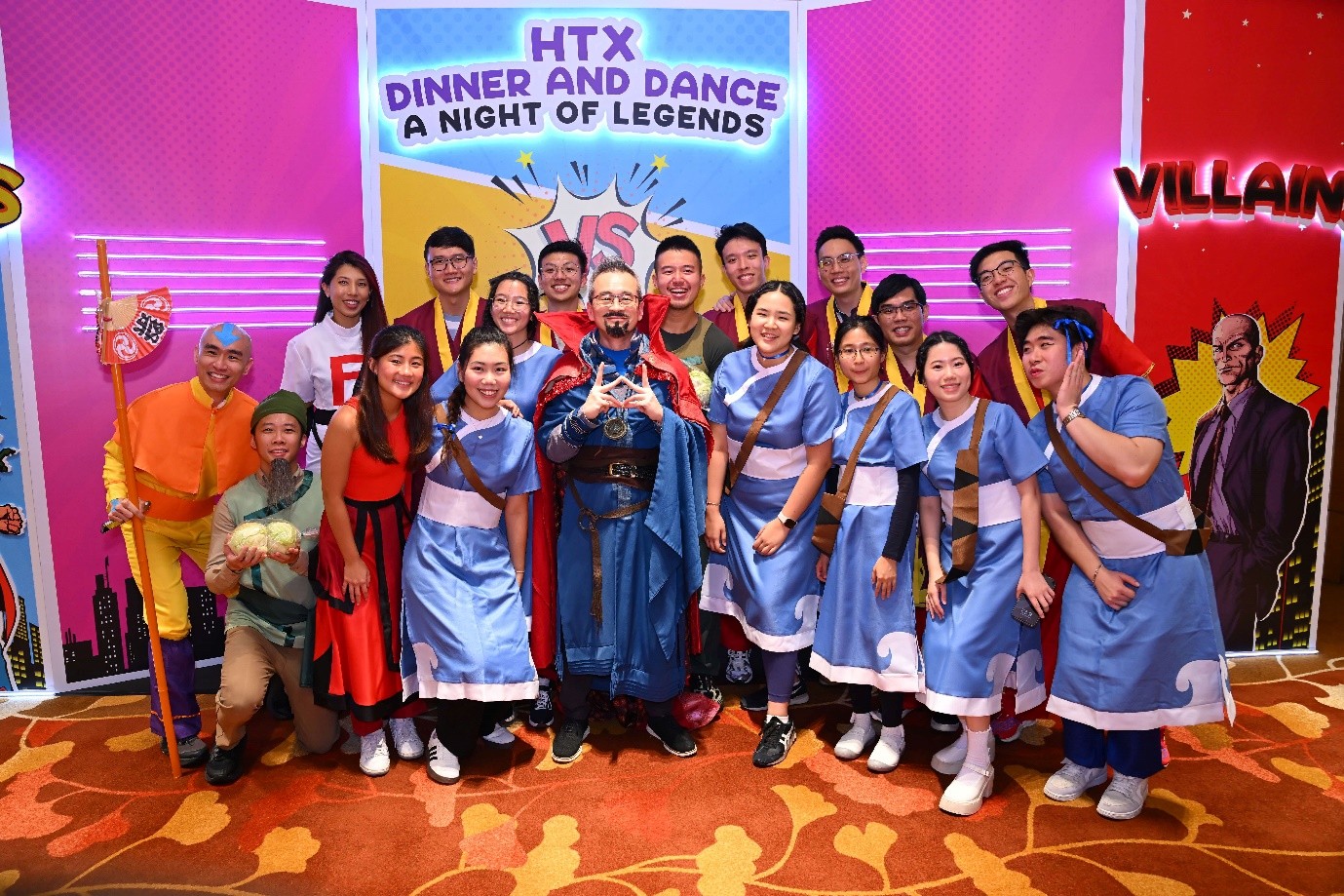 A group of people posing for a photo in colourful costumes.