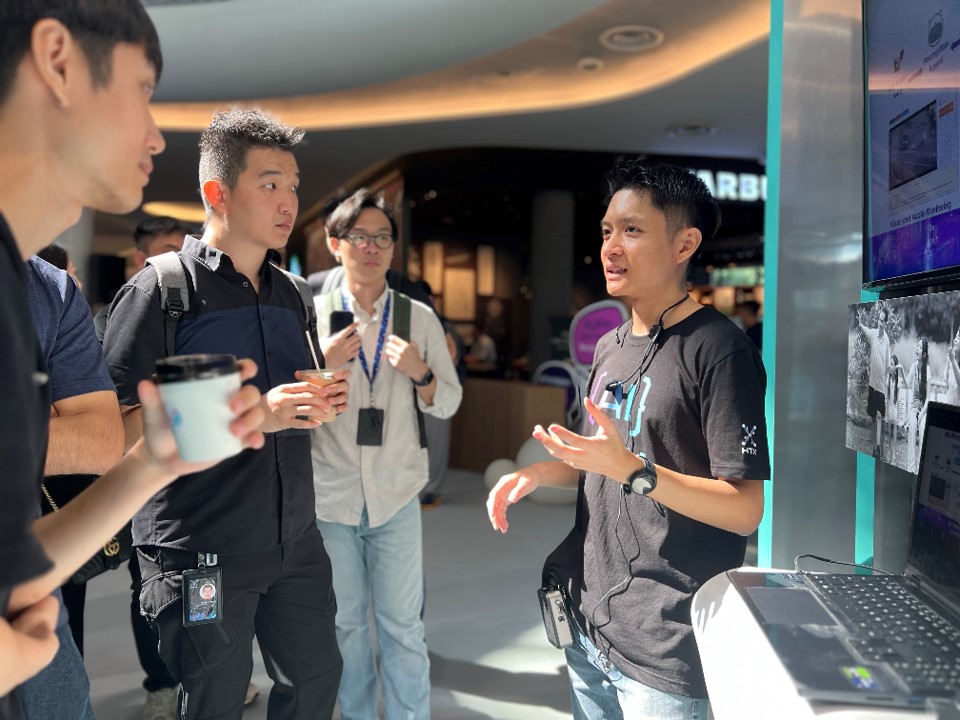 Man explaining to three visitors.