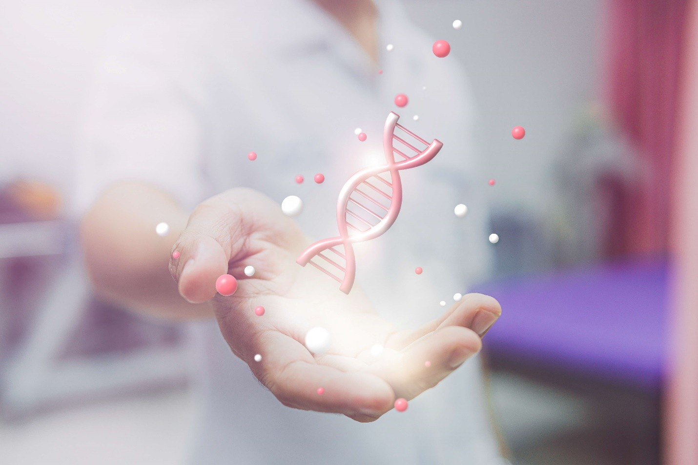 A hand holds up a glowing, holographic double helix of DNA surrounded by tiny red and white particles.