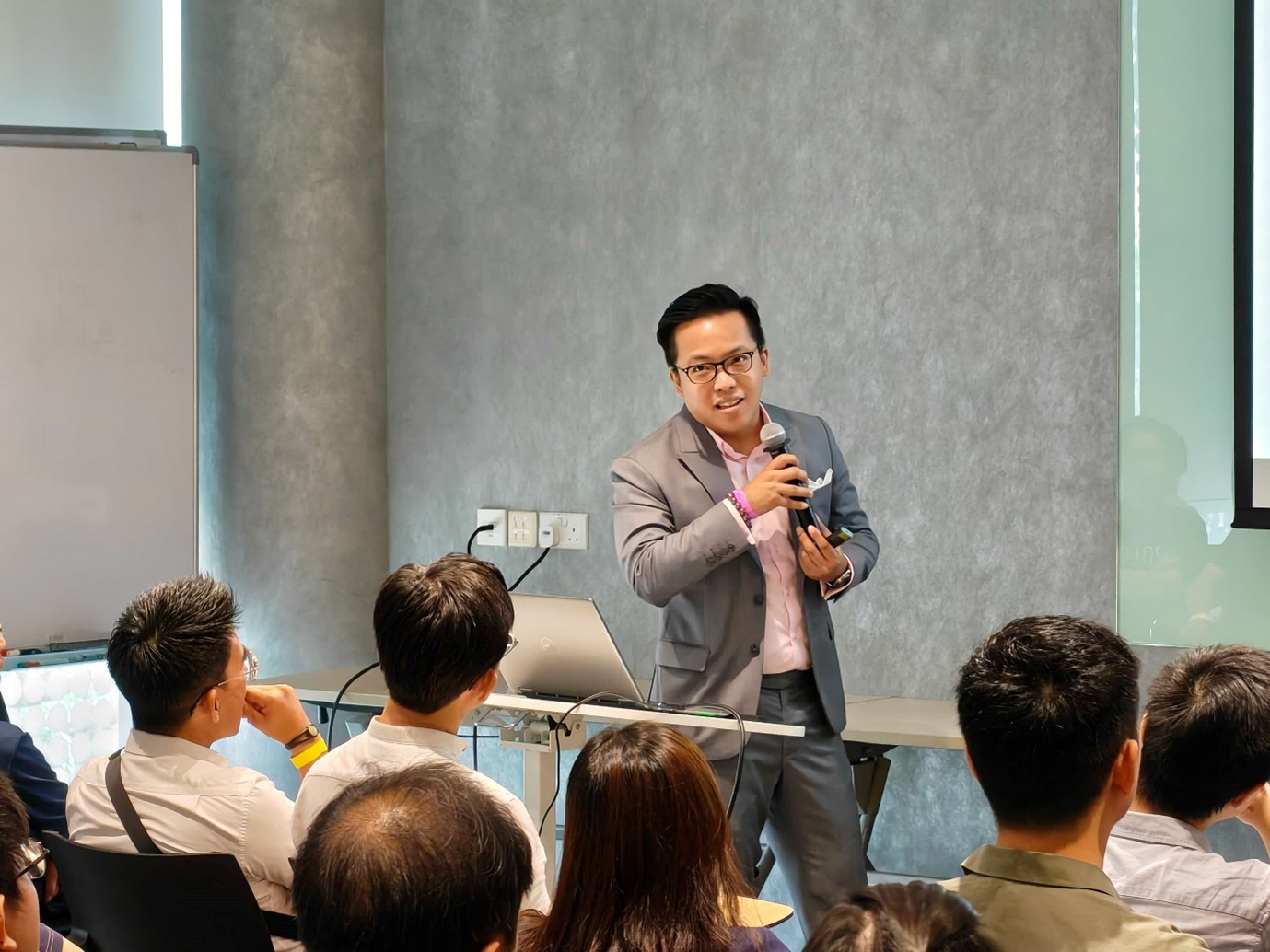 A man standing in front of a seated audience.