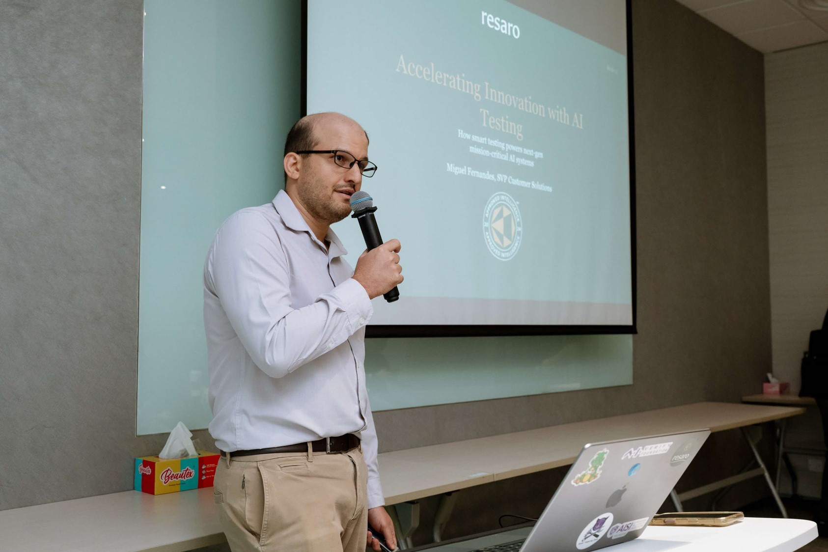 A man standing with a microphone.