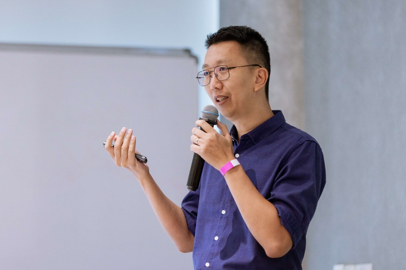 A man standing with a microphone.