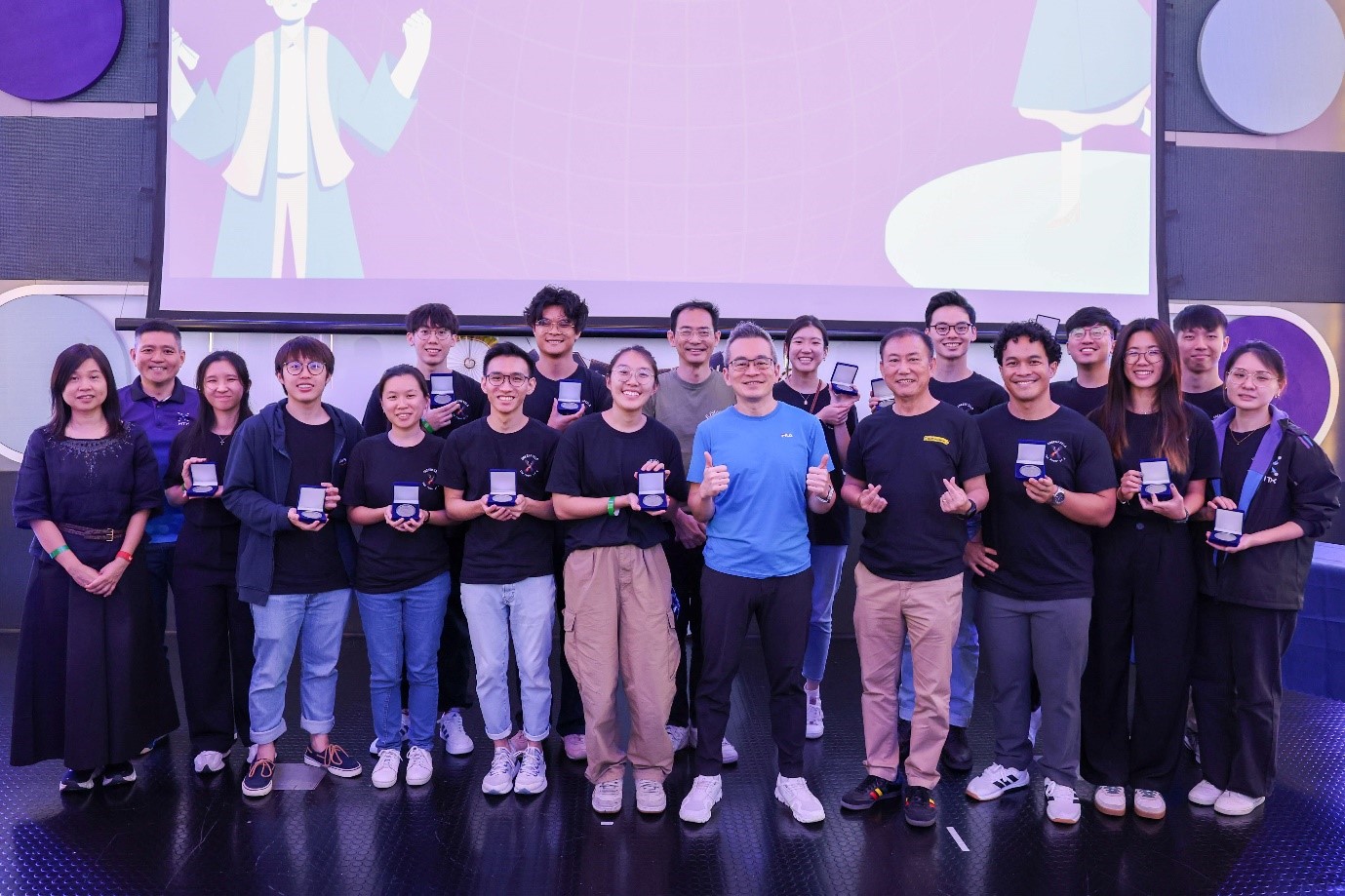 A large group of people holding medallions and smiling for the camera.