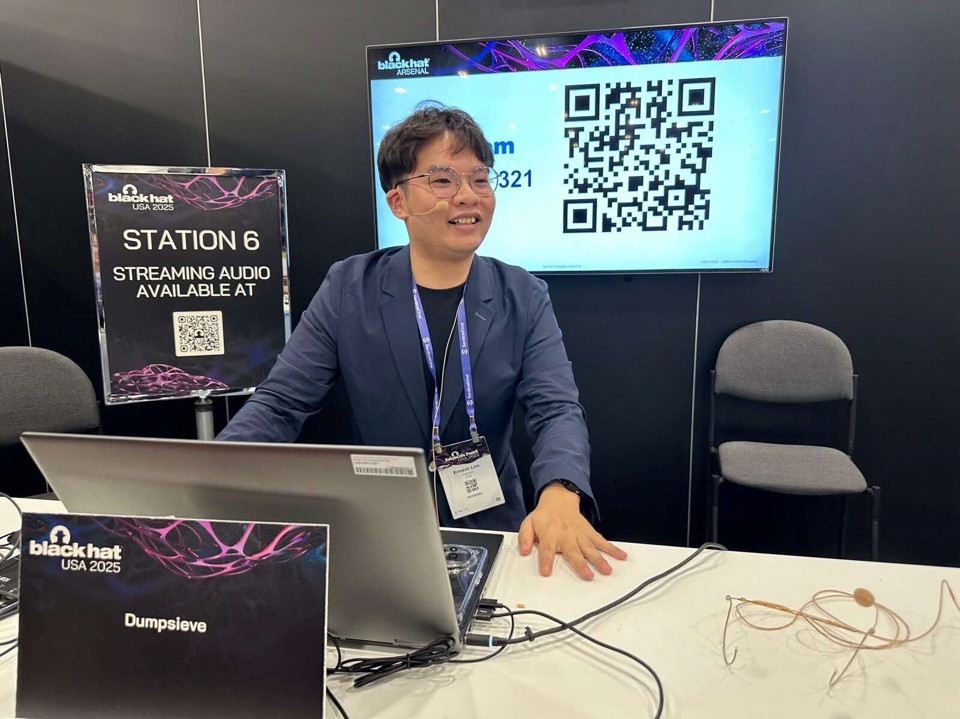 A man sitting at a table with a computer.