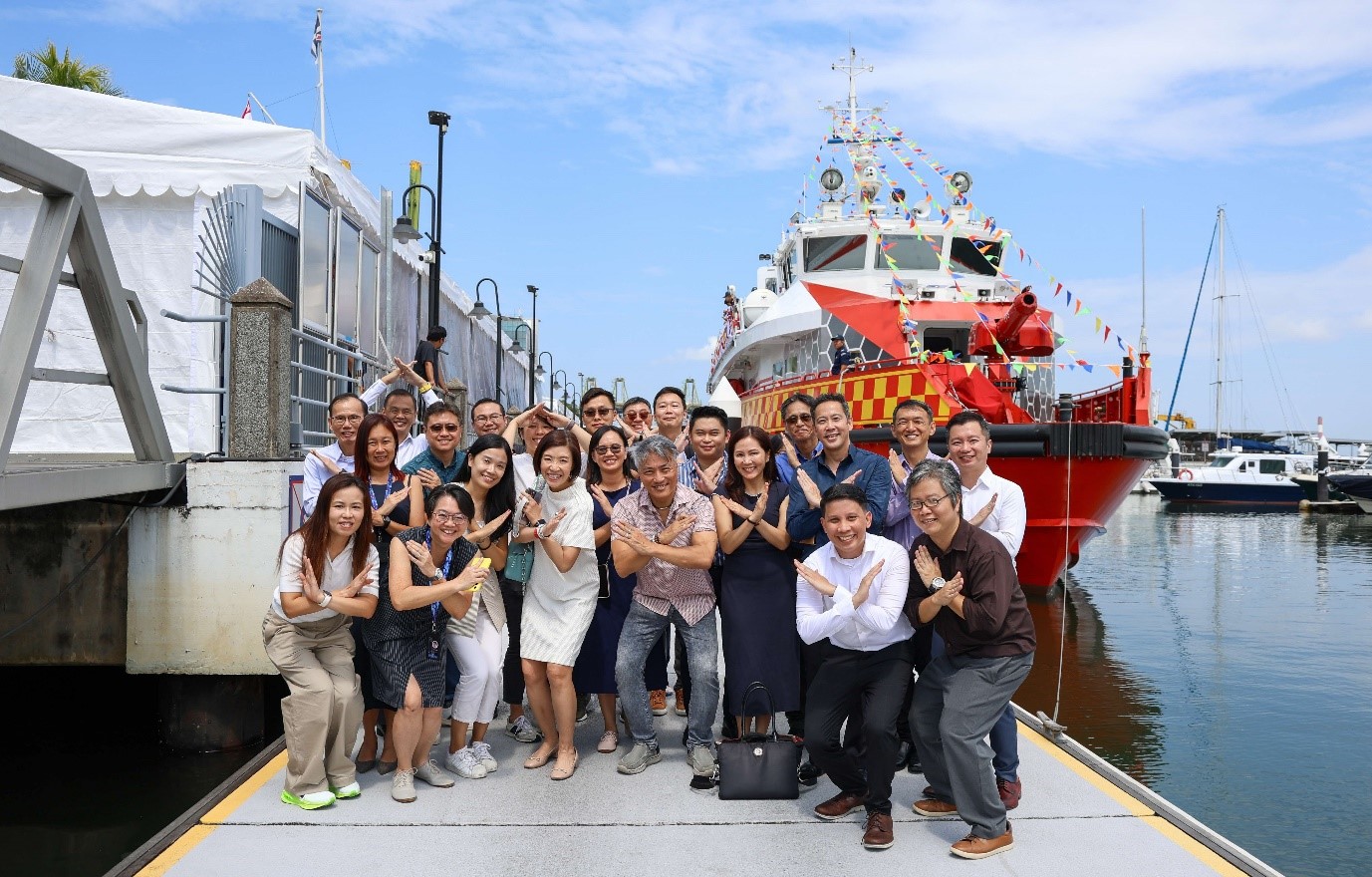 Group of people next to a ship.