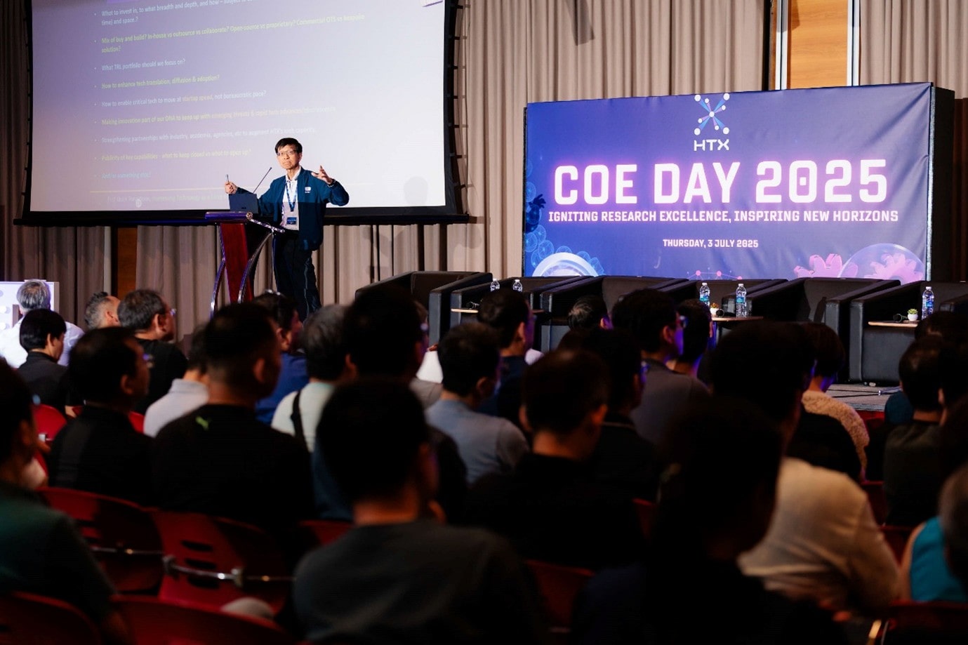 Man speaking on stage in front of audience