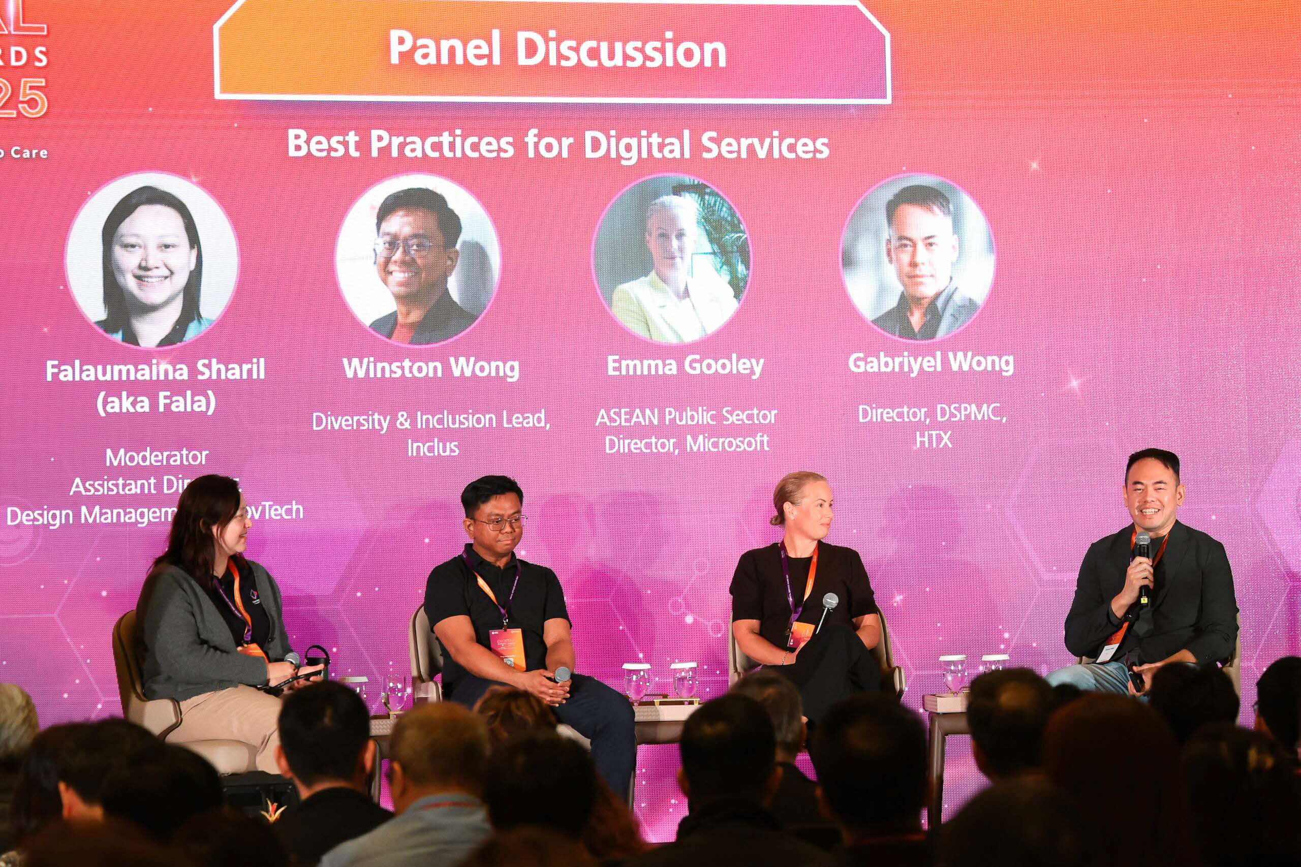 Group of people seated on stage.