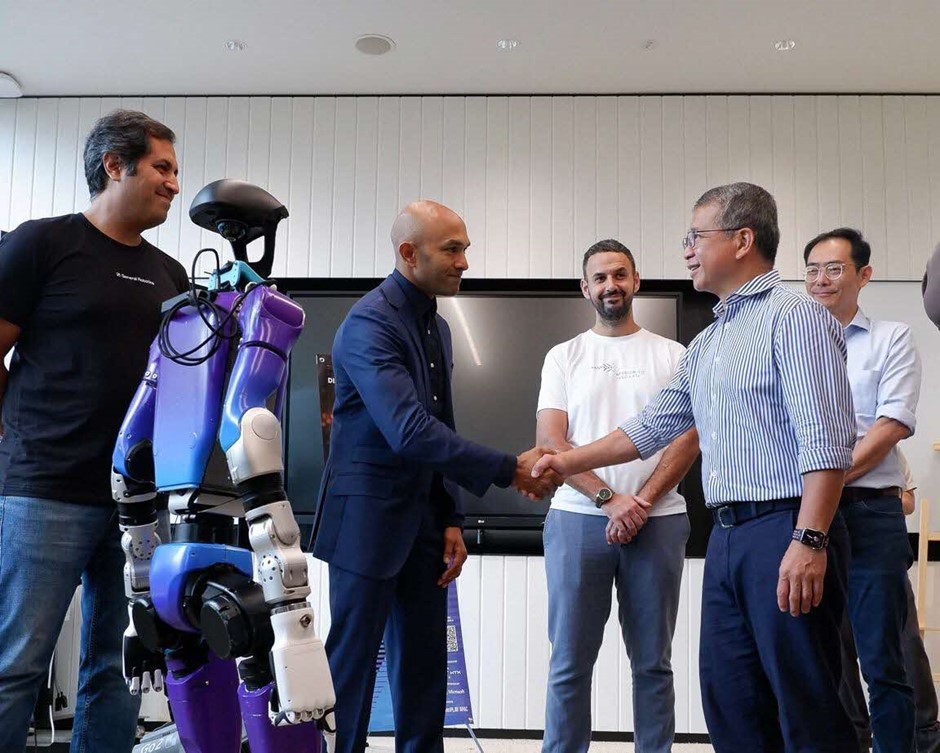 Two men shaking hands in a group of people.