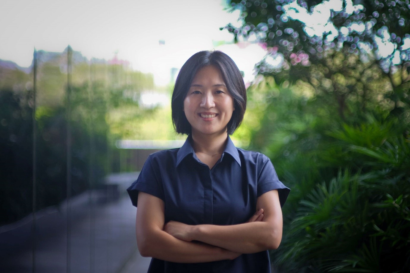 A lady smiling, posing for a photo.