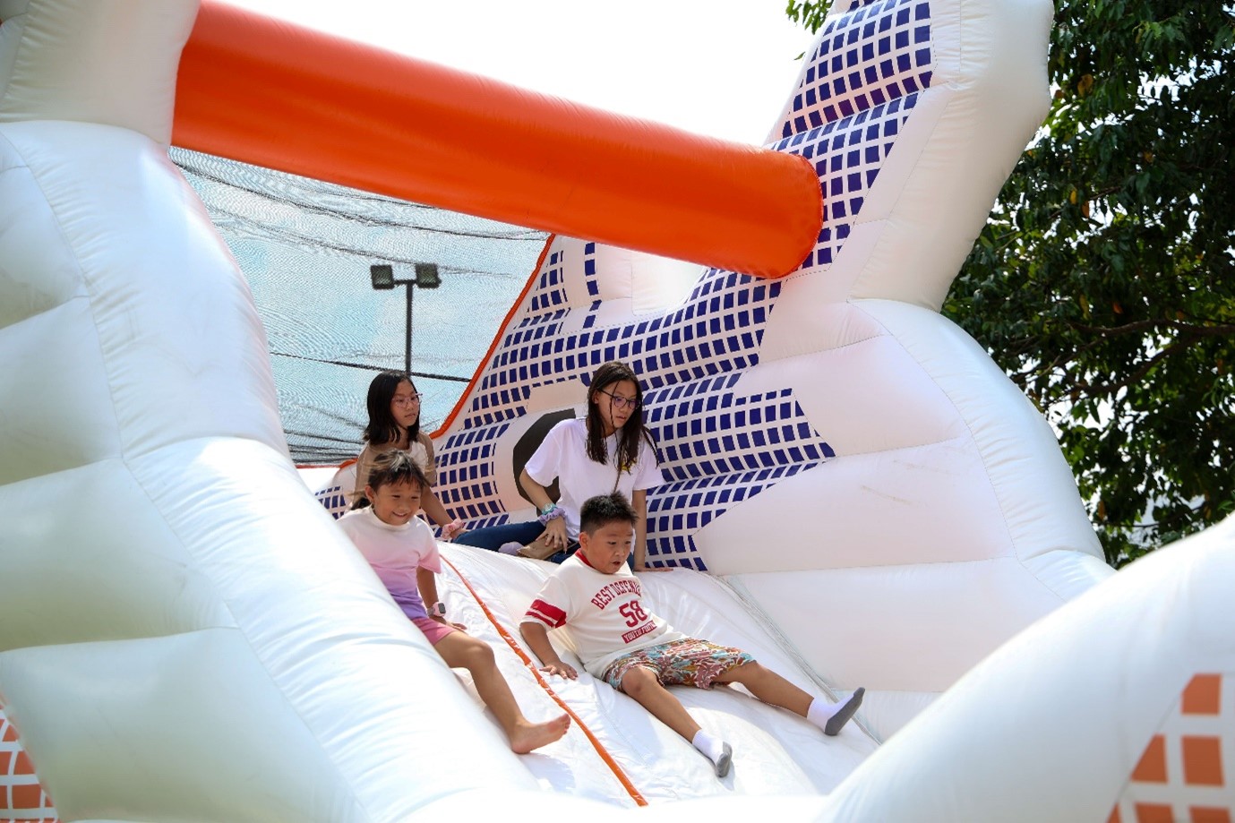 An inflatable slide at the outdoor carnival at HTX Family Day 2025.