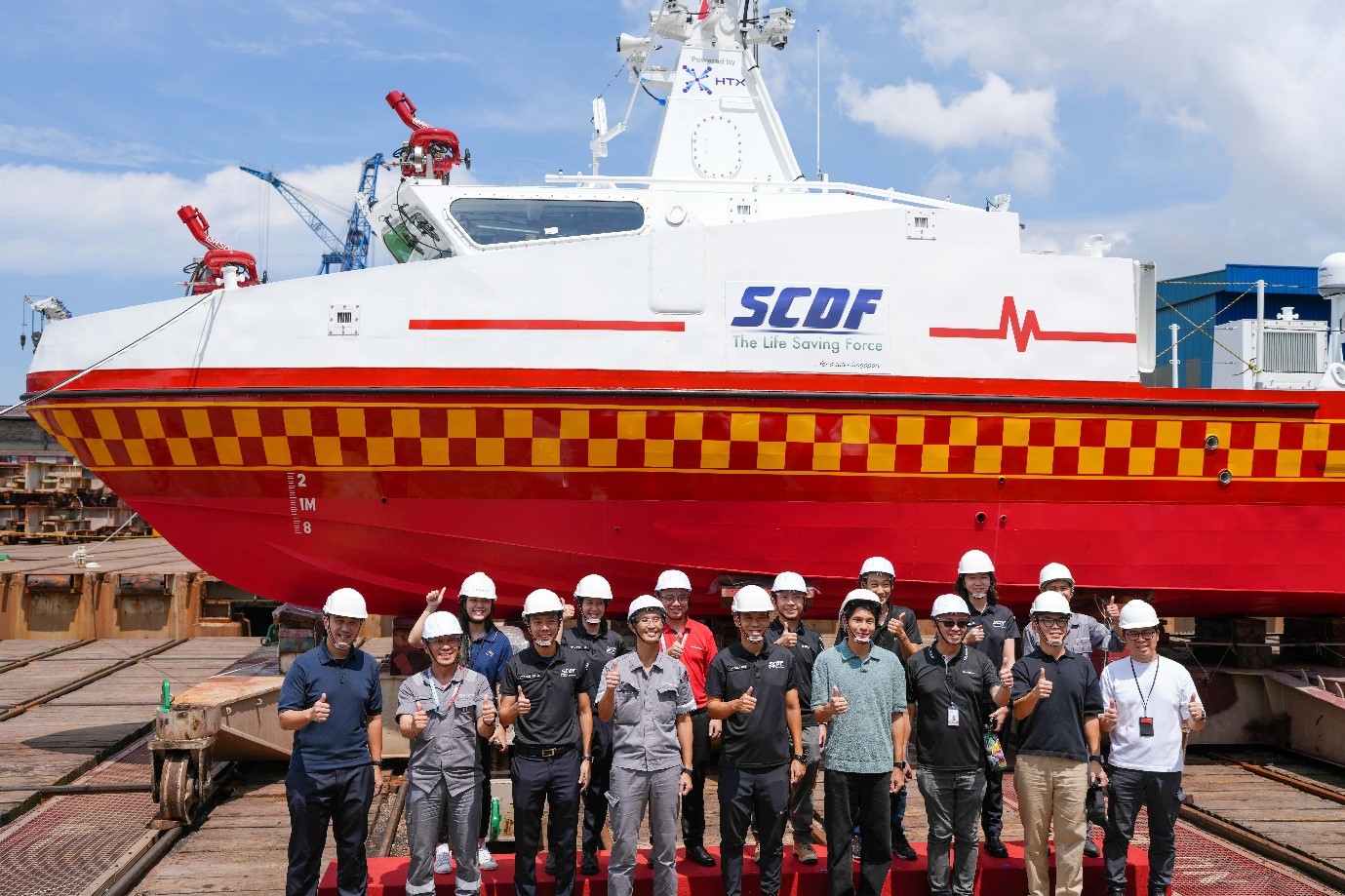 A group of people standing in front of a boat.