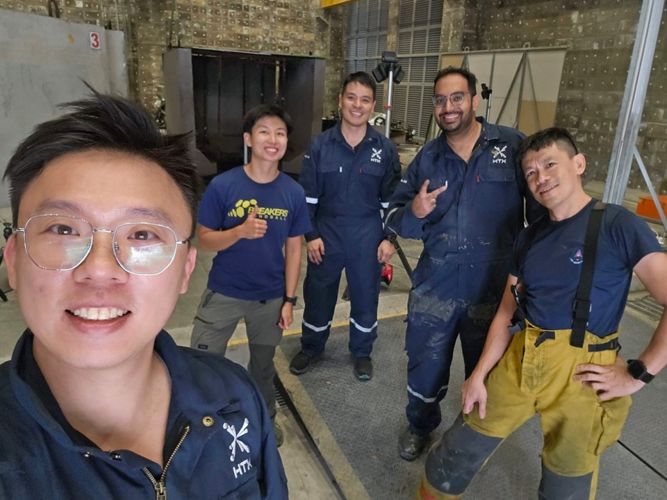 A group of five men mostly in overalls.