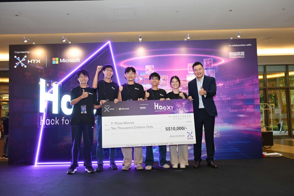 A group of people pose with mostly thumbs up while holding up a giant S$10,000 cheque for 1st Prize Winner.