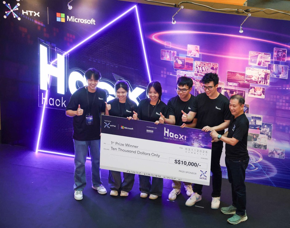 A group of people pose with smiles and thumbs up while holding up a giant S$10,000 cheque for 1st Prize Winner.