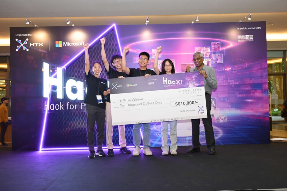A group of people pose with fists in the air while holding up a giant S$10,000 cheque for 1st Prize Winner.