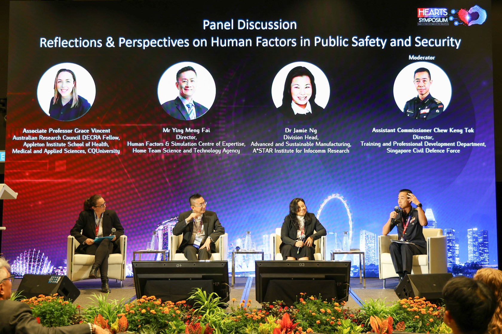 A group of four men and women sitting on stage.