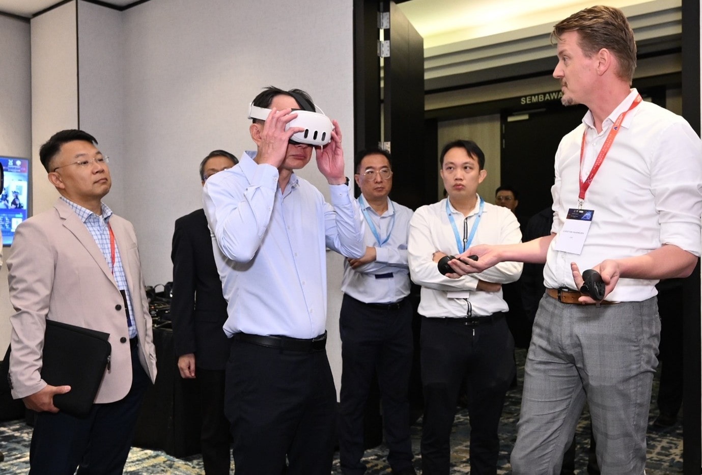 A group of men standing around a man wearing goggles.