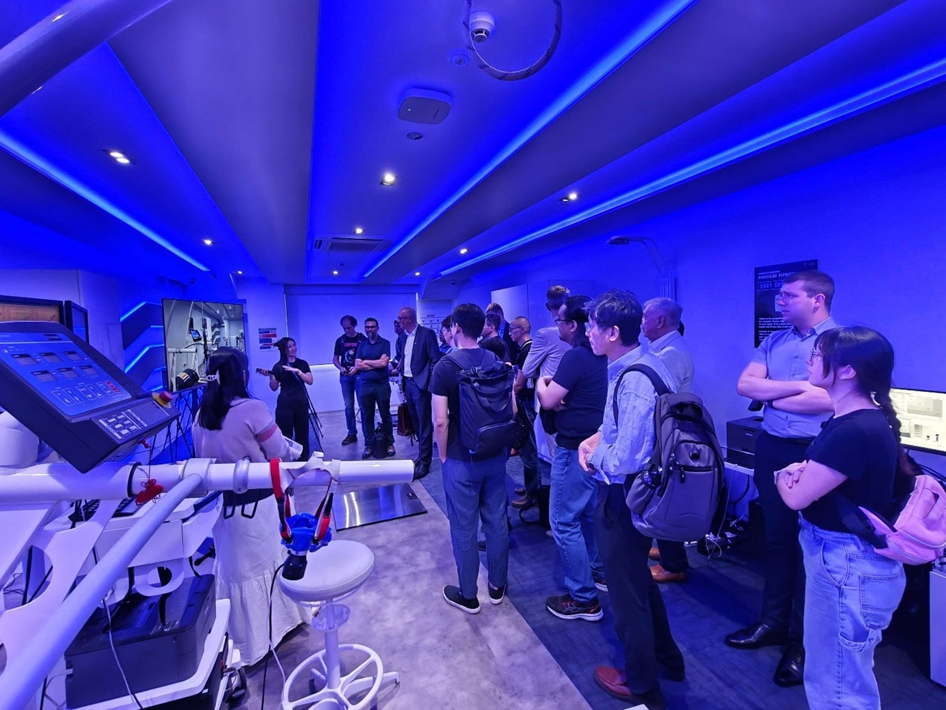 A group of people standing in a room.