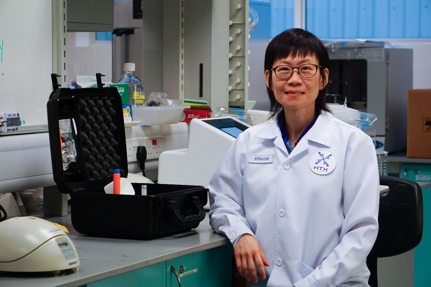 A lady in a white lab coat.