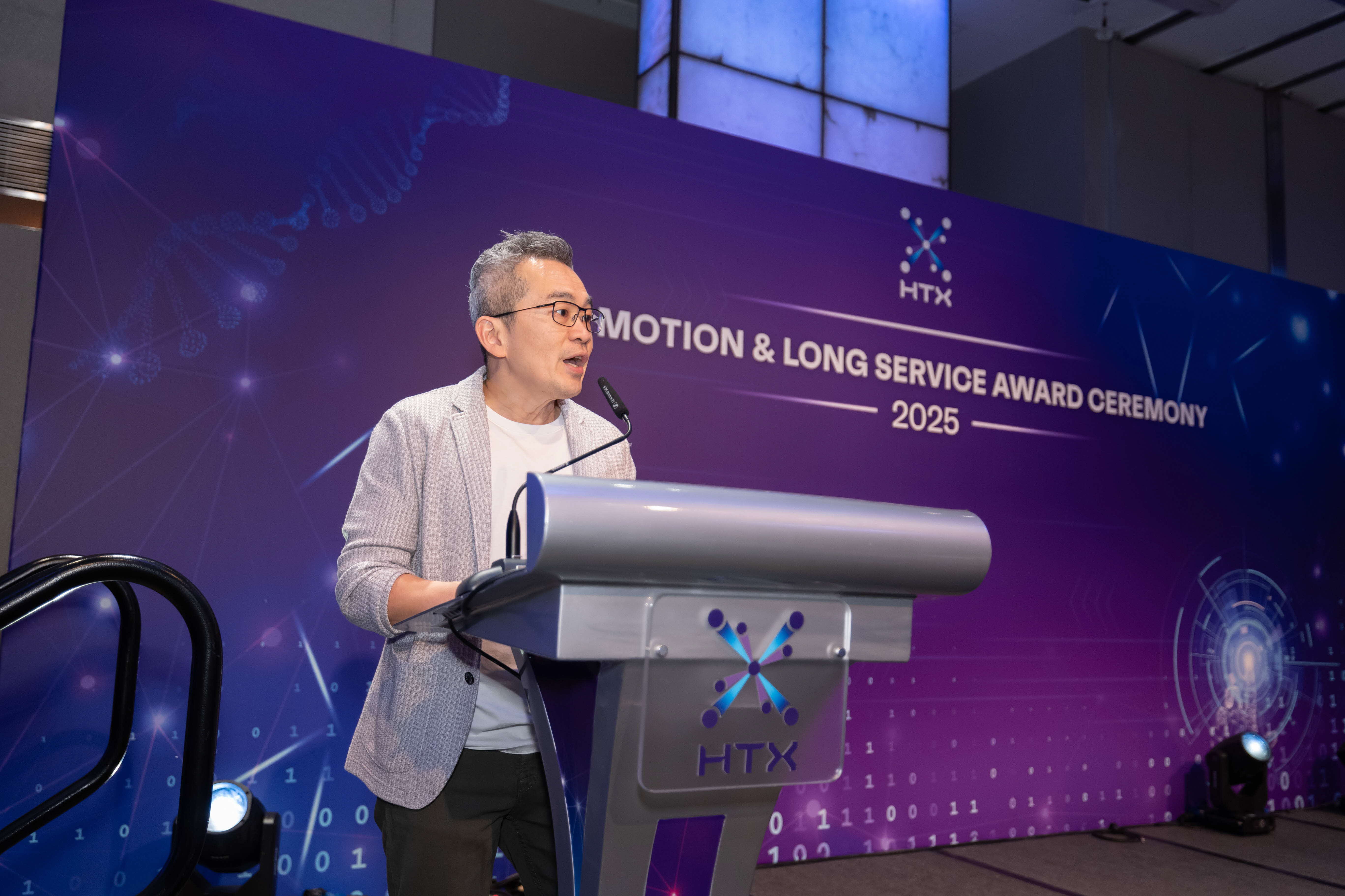 Man speaking on stage.