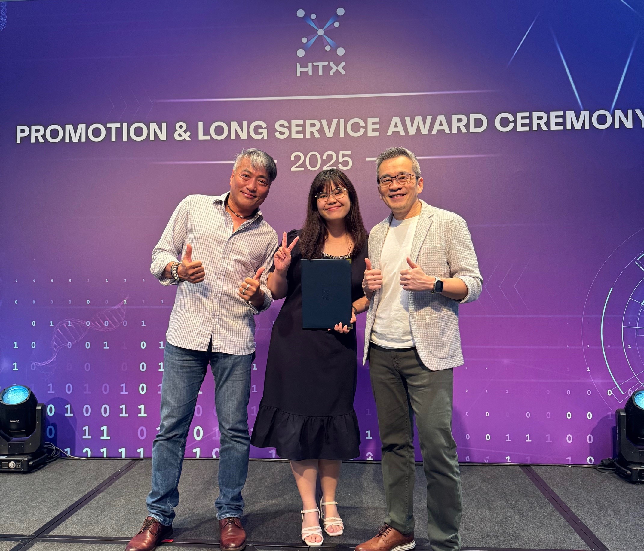 Three people posing.