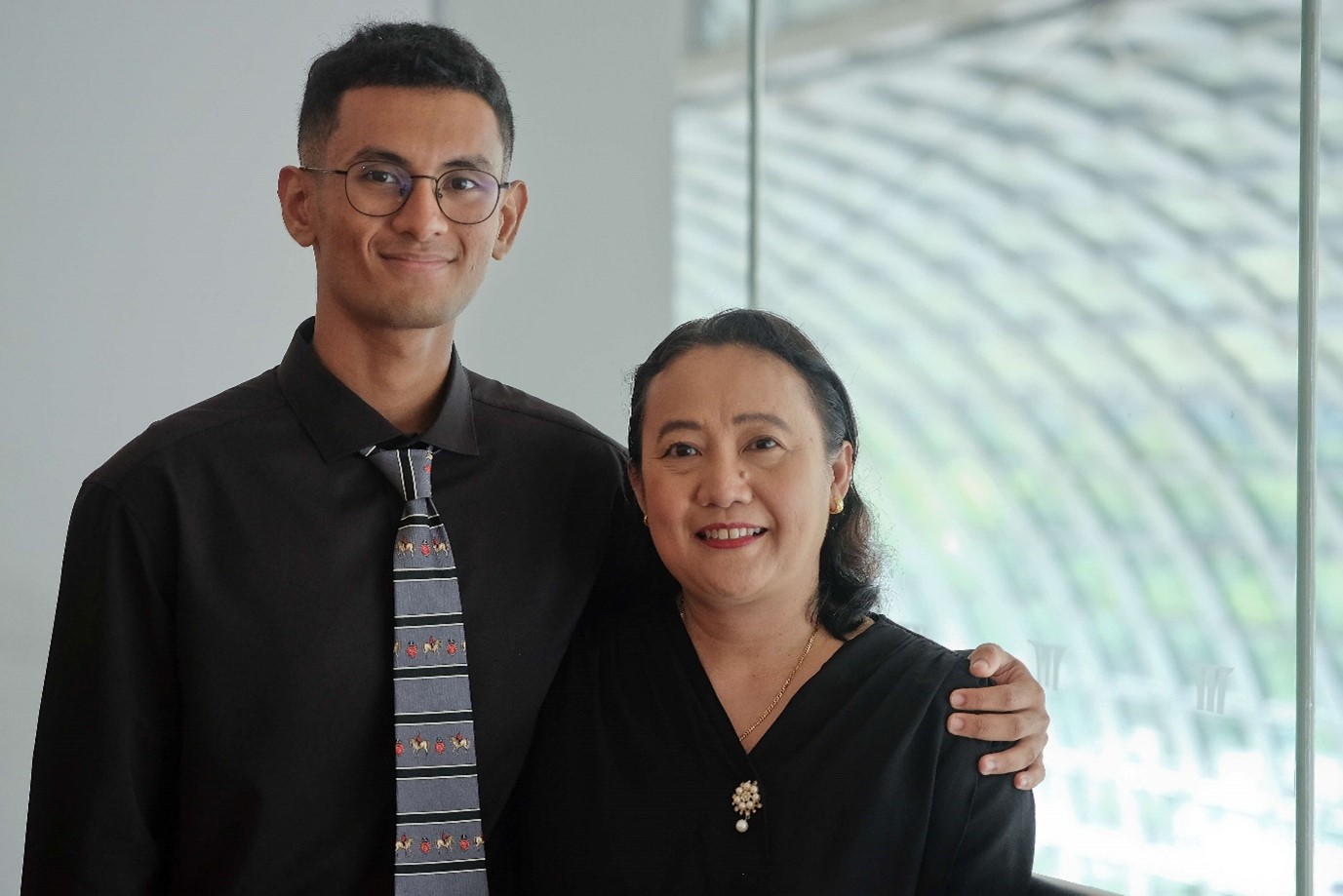 A young man and woman smiling.