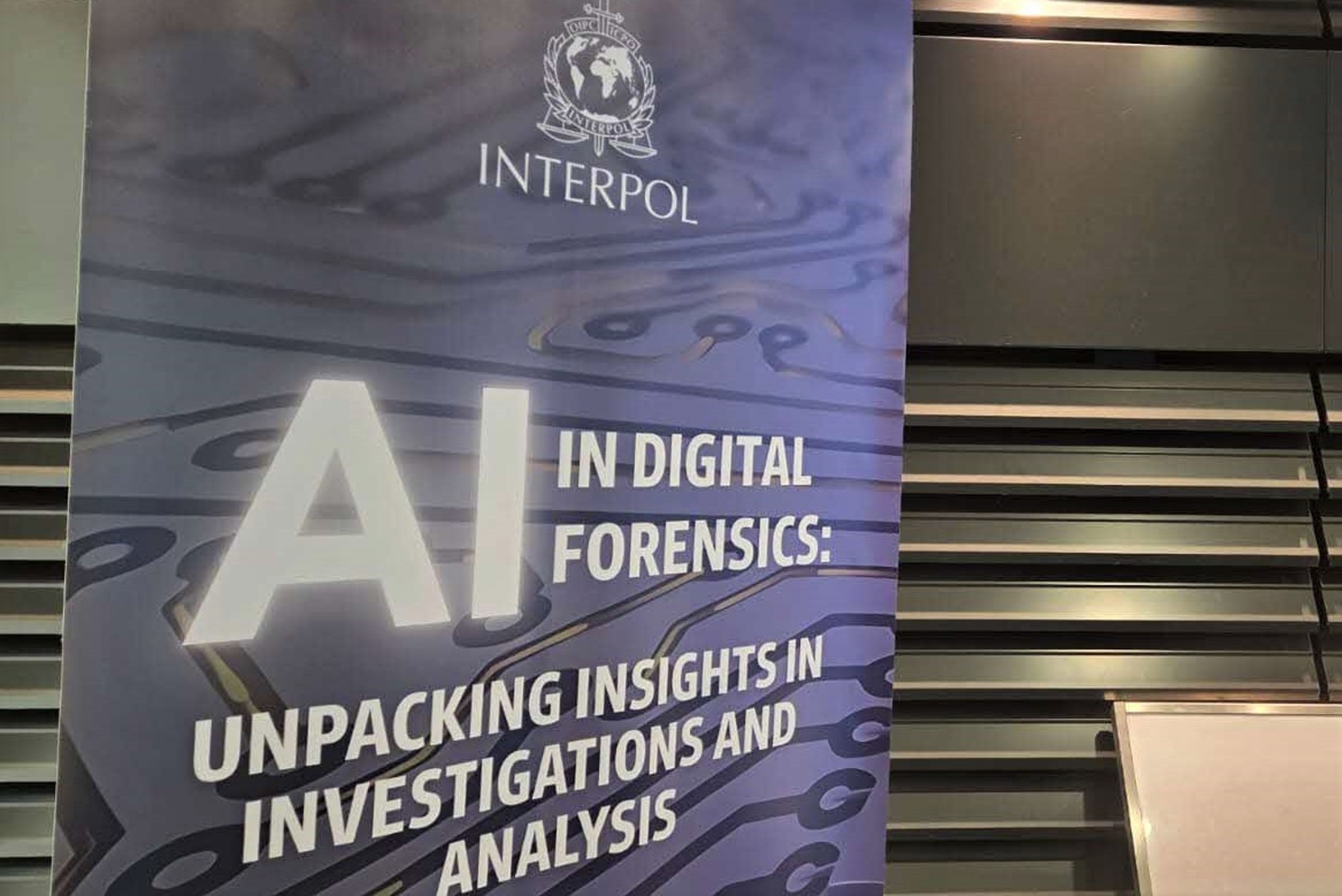 A close-up of the Interpol banner for the "AI in Digital Forensics" event.