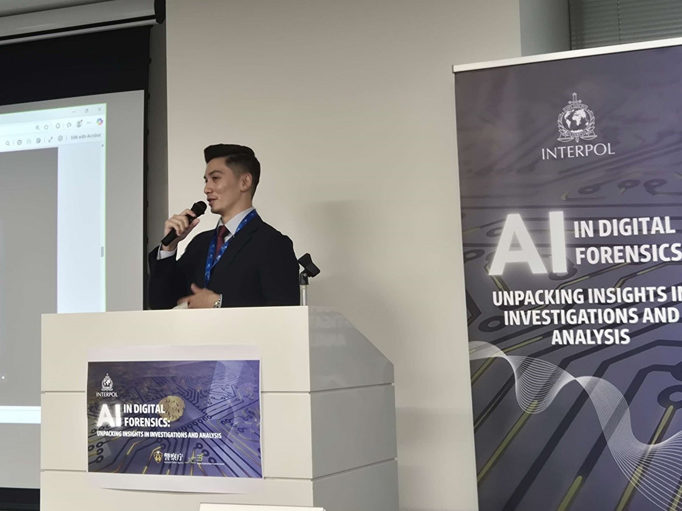 A man standing at a podium speaking into a microphone.