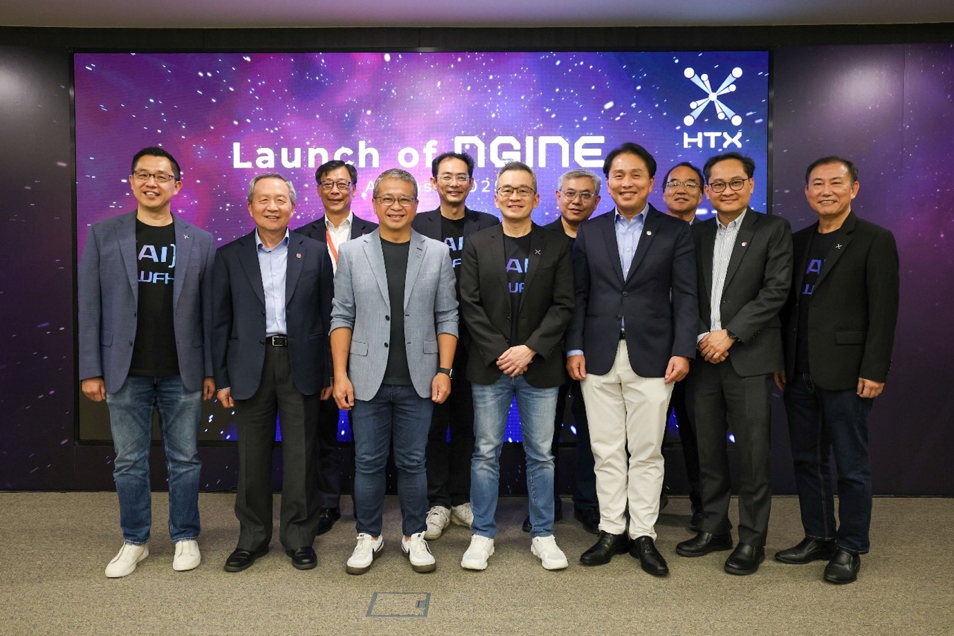 A group of men standing in front of the launch backdrop.