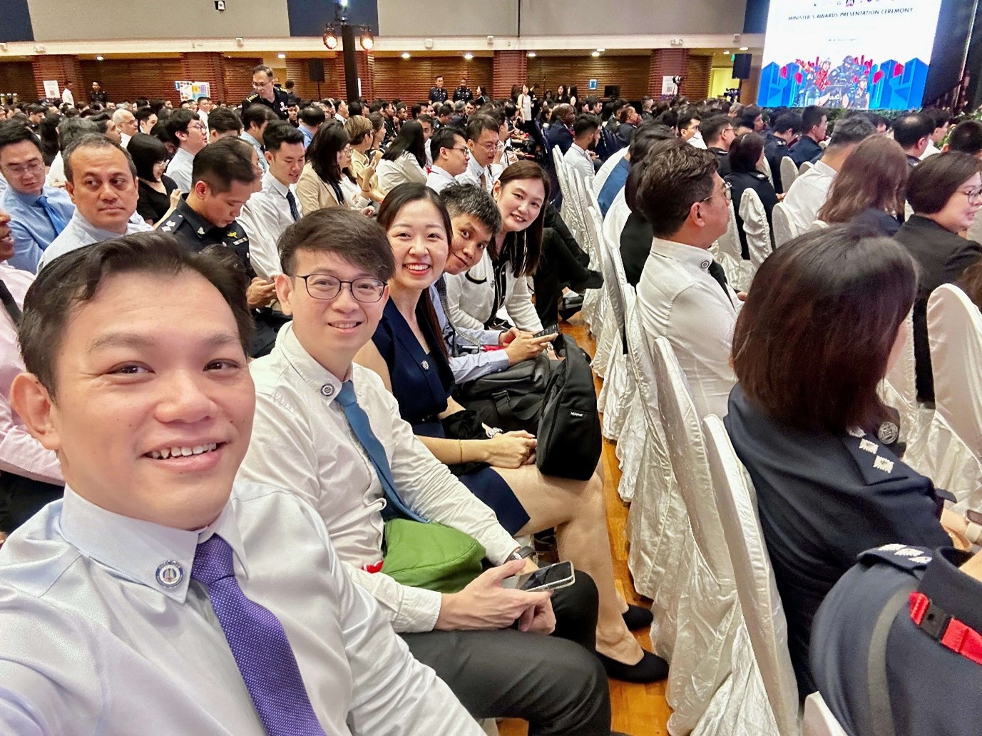 Group selfie of attendees smiling during the awards ceremony.
