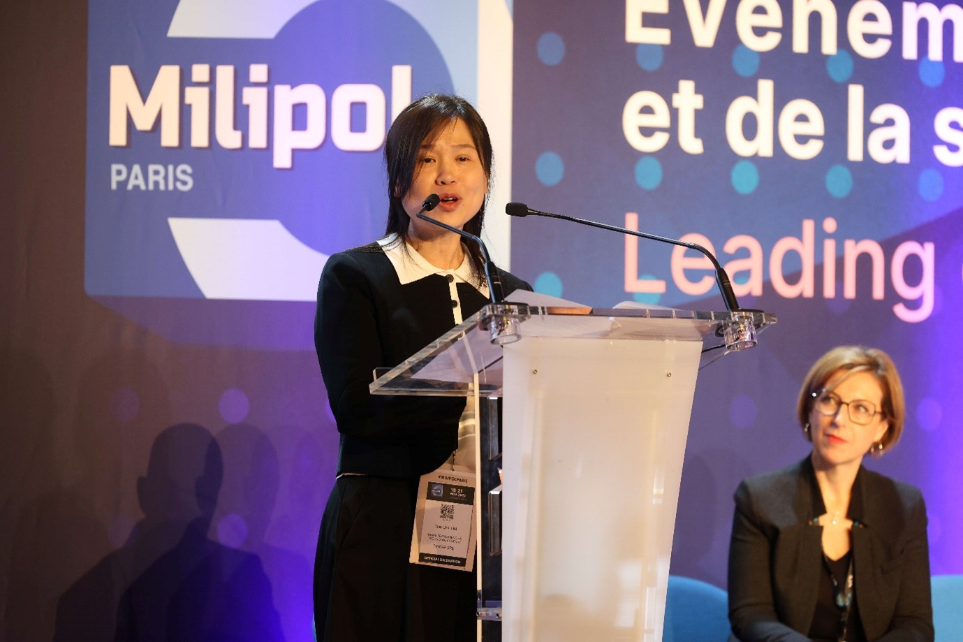 A woman speaking at a podium.