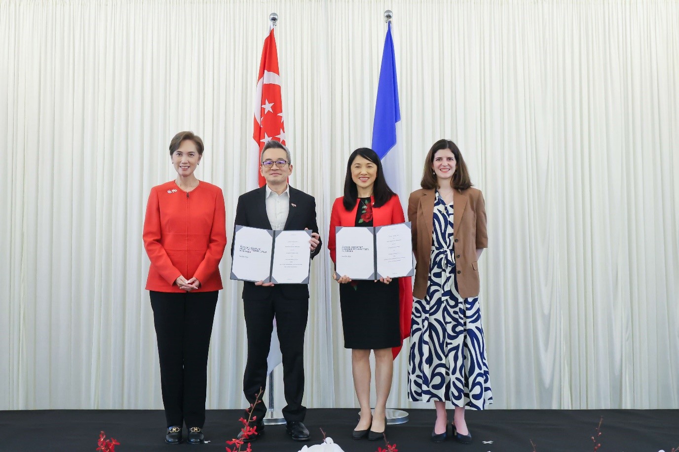 Three women and one man posing.
