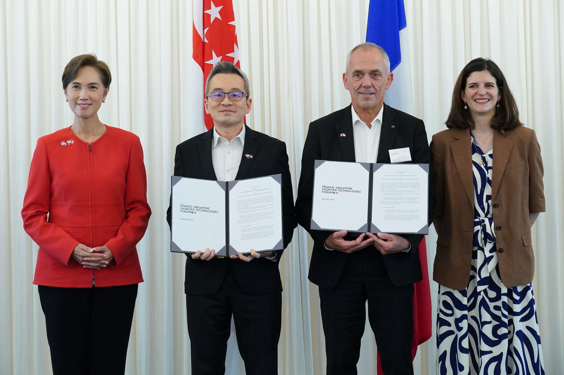 Two women and two men posing.