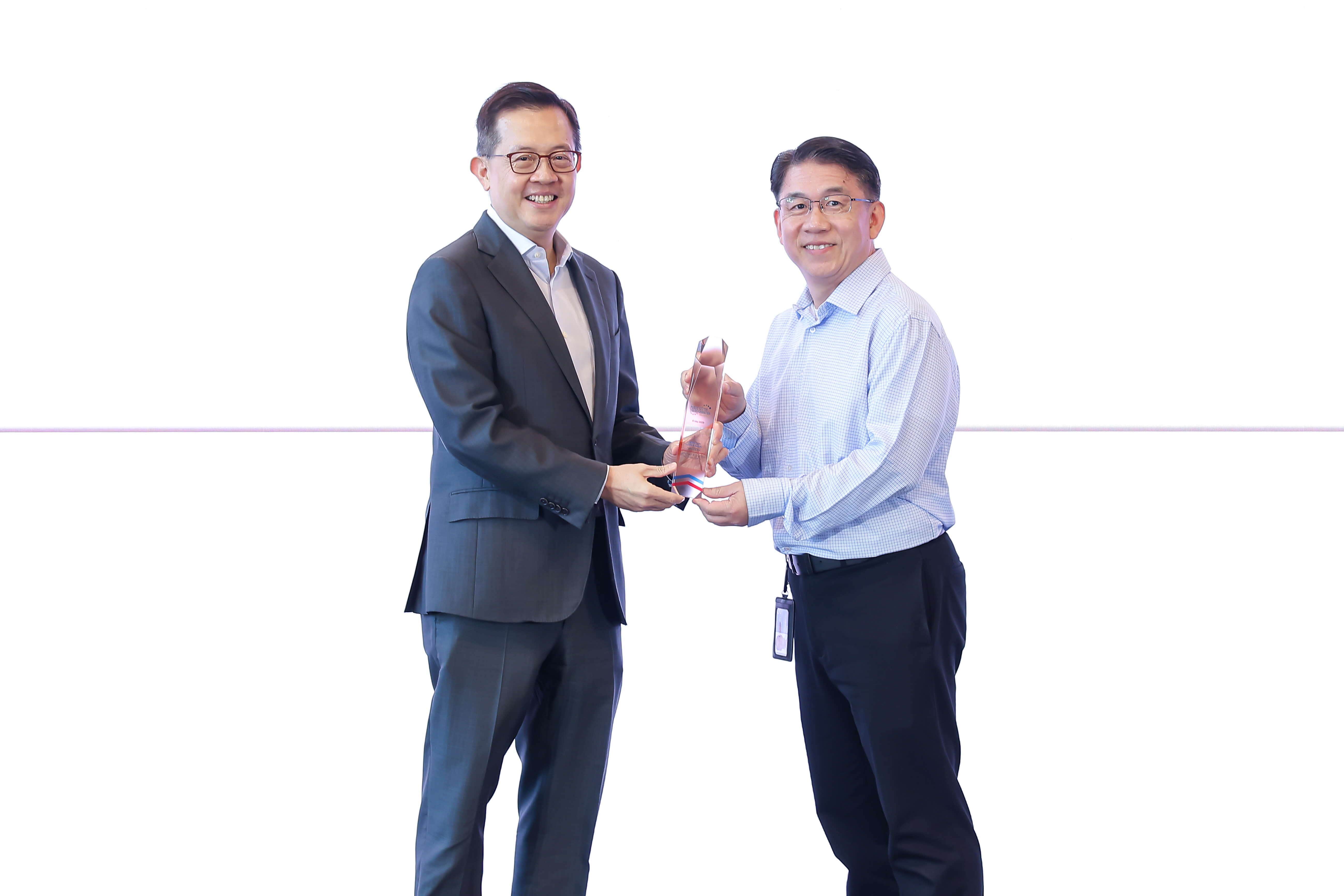 One man giving an award to another man.