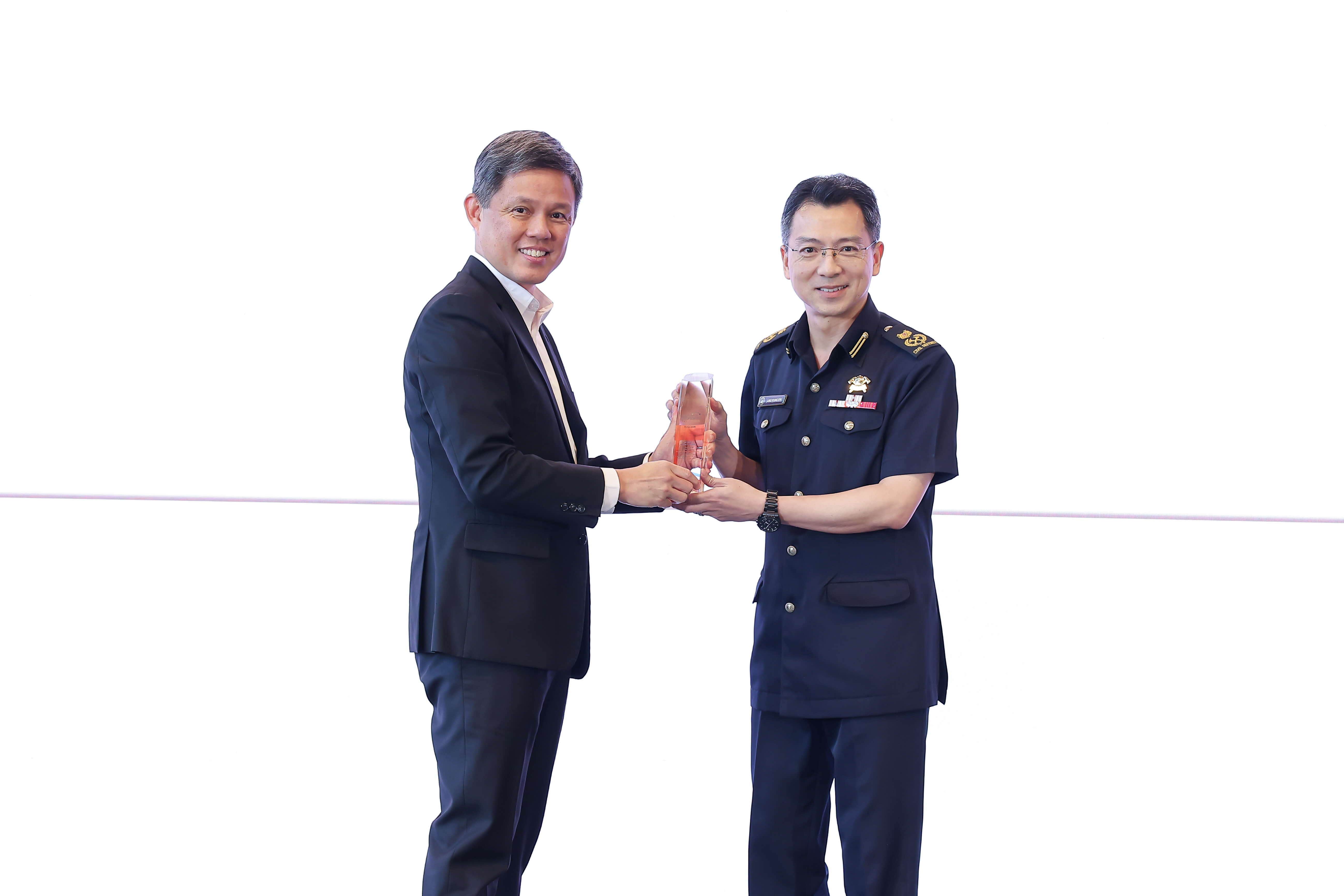 One man giving an award to another man.