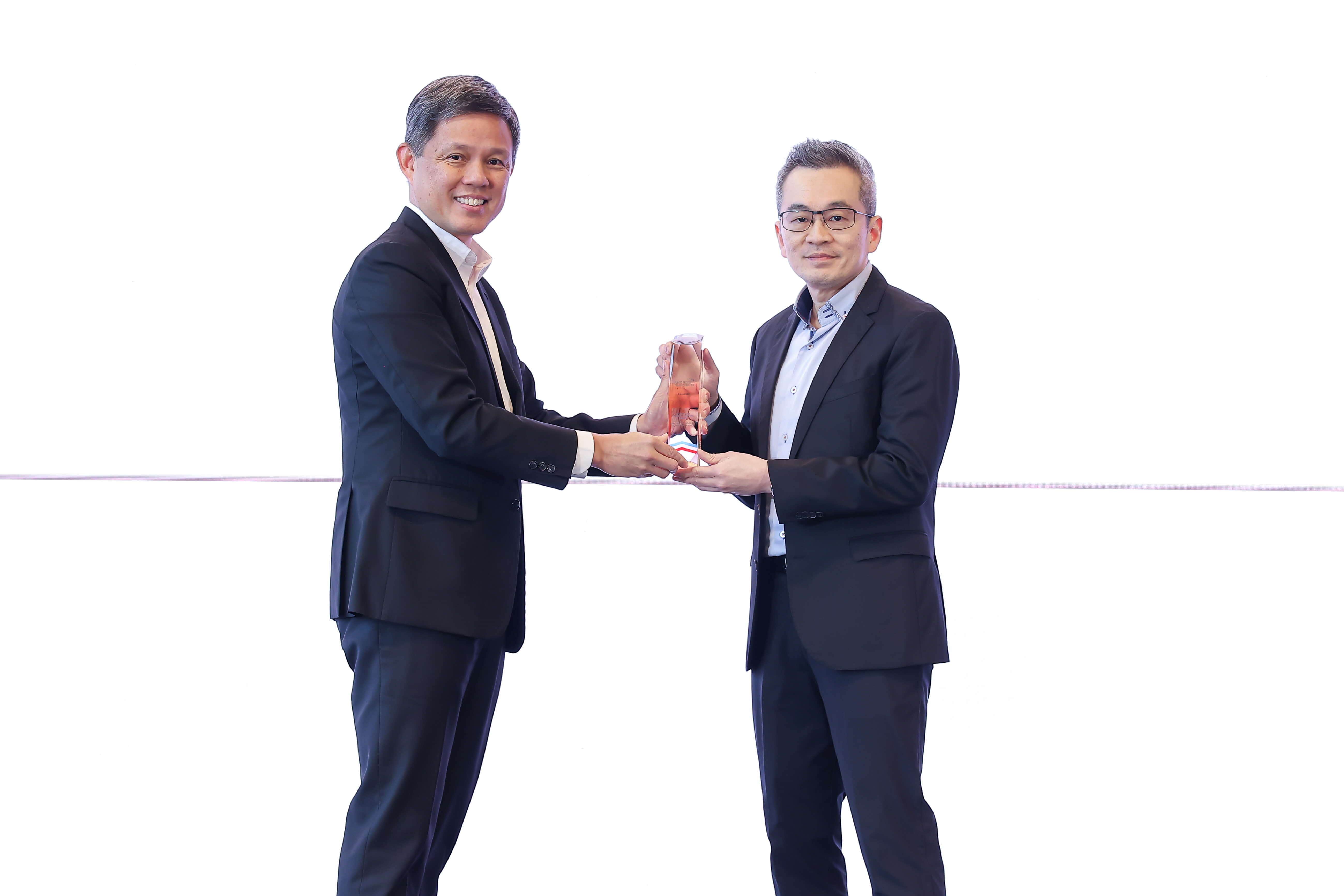 One man giving an award to another man.