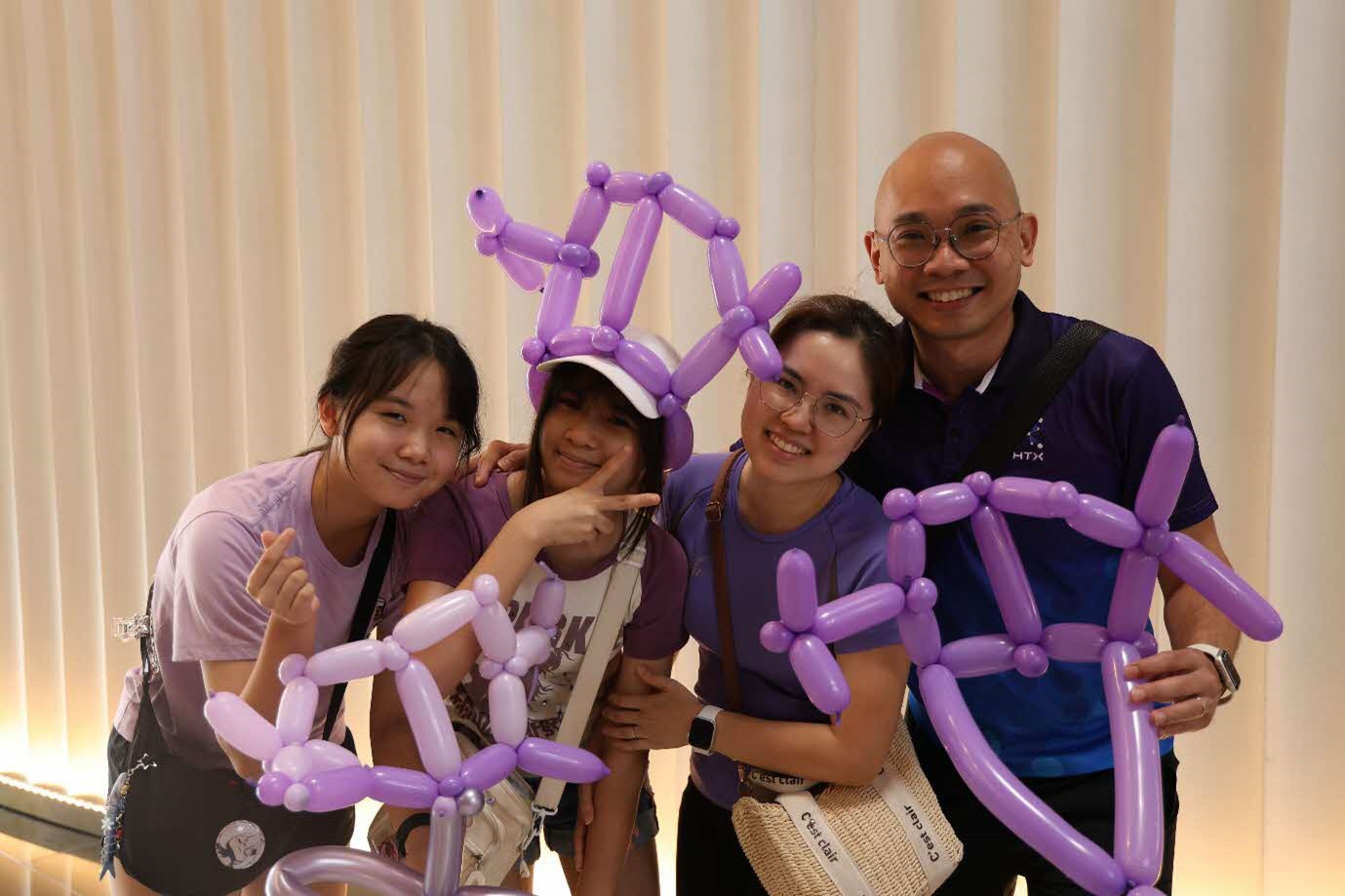 A group of people posing with balloons.