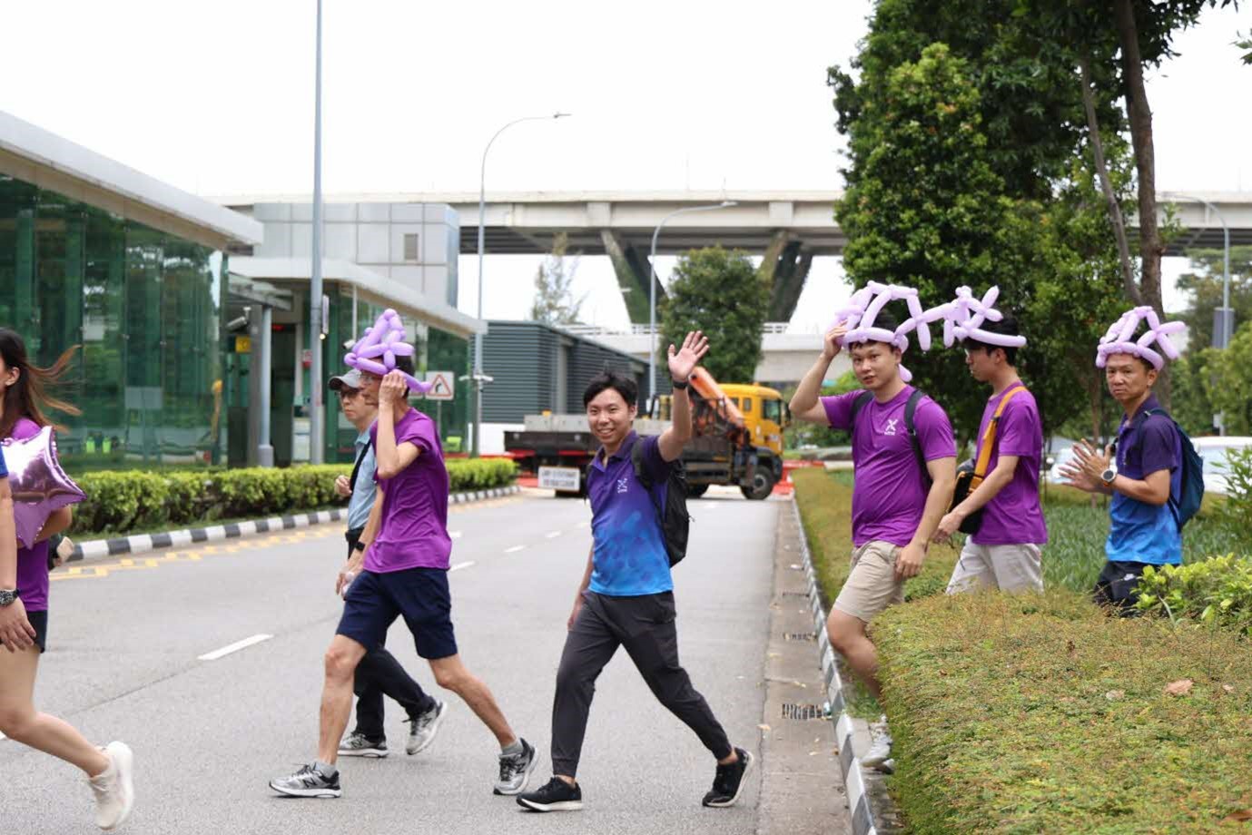 A group of people walking on a street.