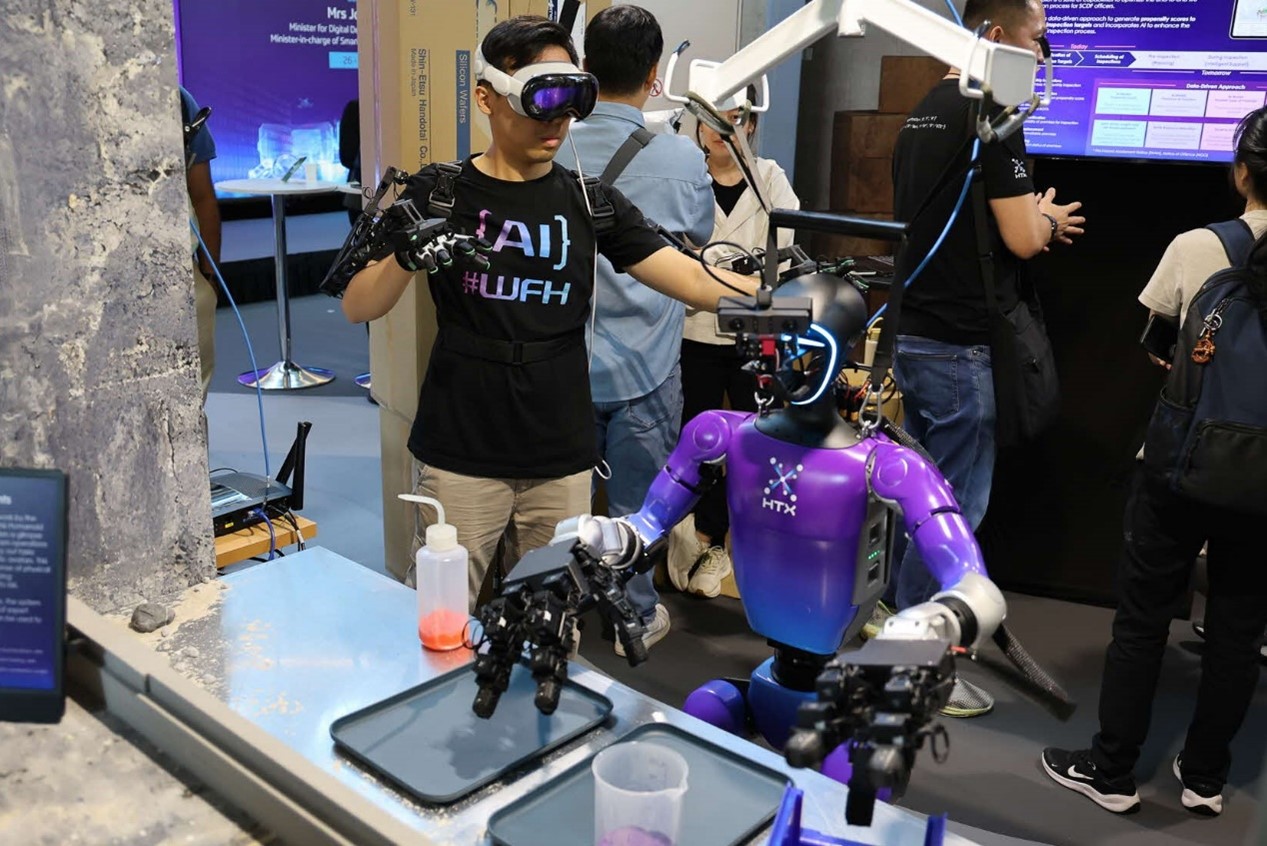 Man demoing humanoid robot.