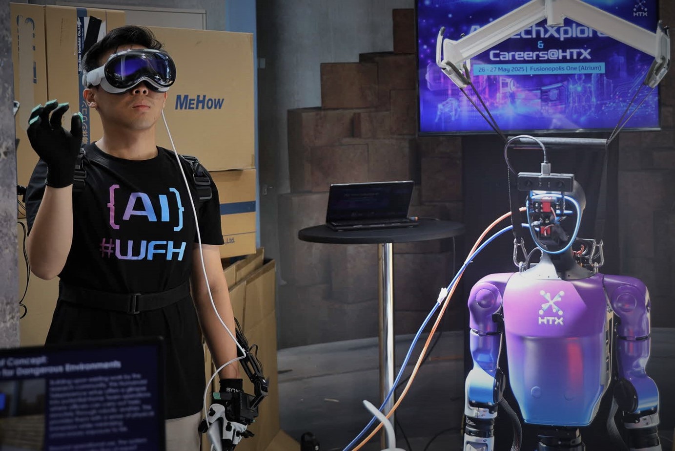 Man demoing humanoid robot.