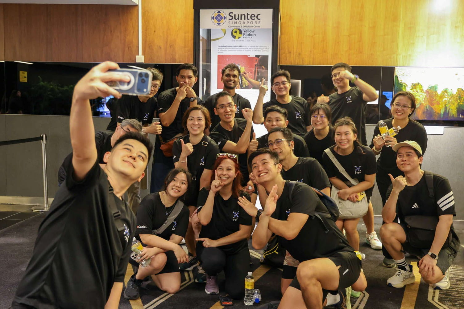 Group posing for a selfie indoors.