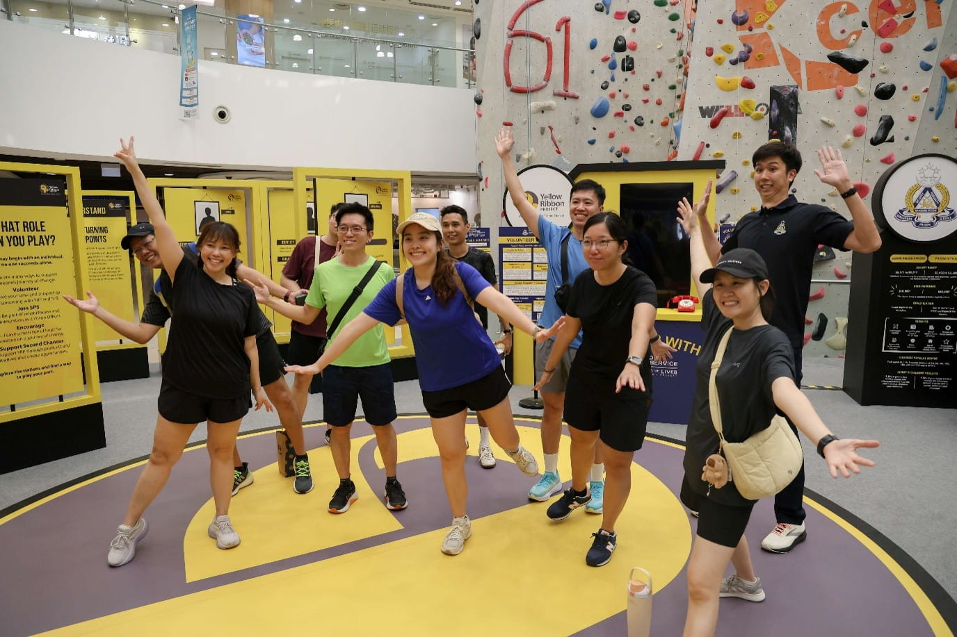 Group posing inside an indoor climbing facility.