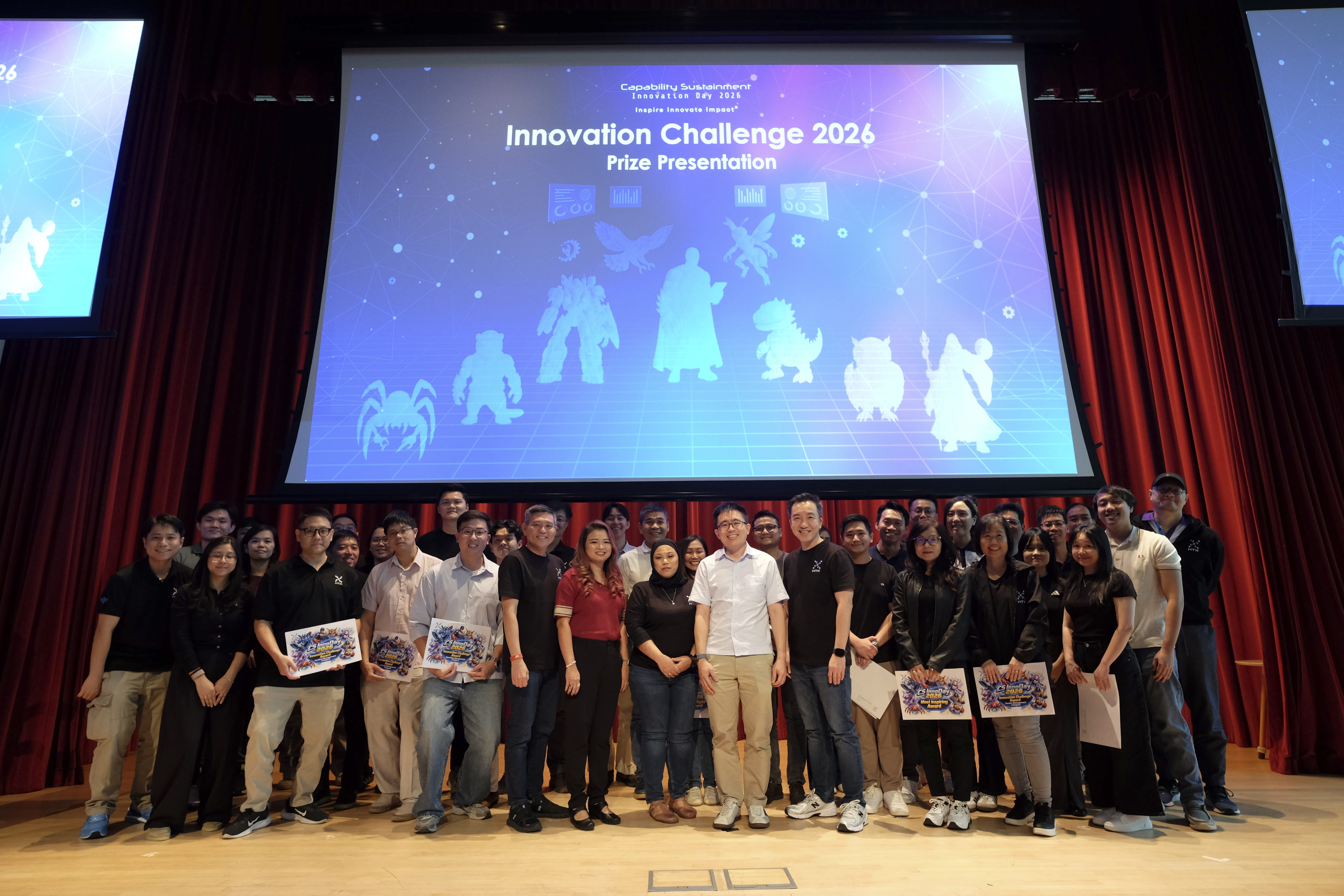 Large group posing on stage during Innovation Challenge 2026 prize presentation.