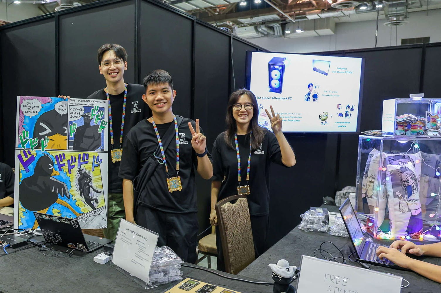 Three people standing behind a booth.