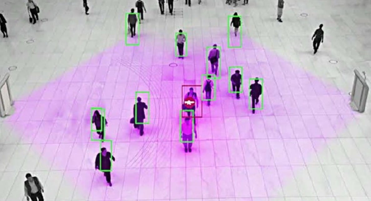 Multiple people walking in an open area.